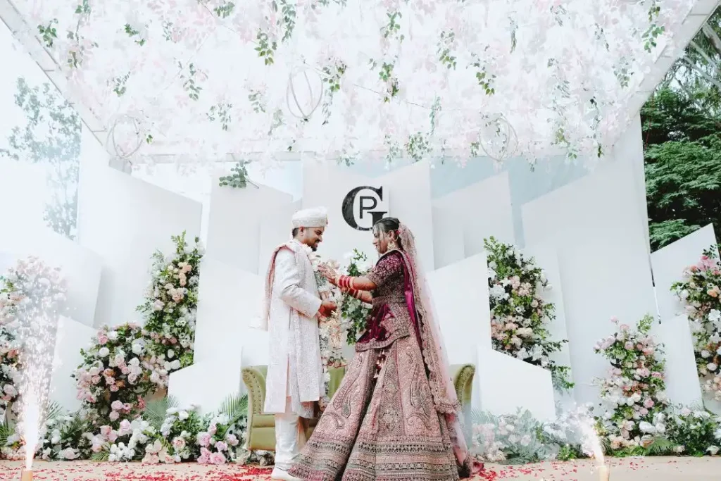 Bride and groom exchanging vows under a floral stage by the best wedding planners in Bangalore