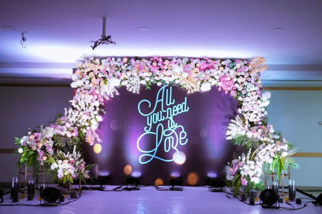 Stylish wedding photo corner with floral lights created by best wedding event organisers in bangalore