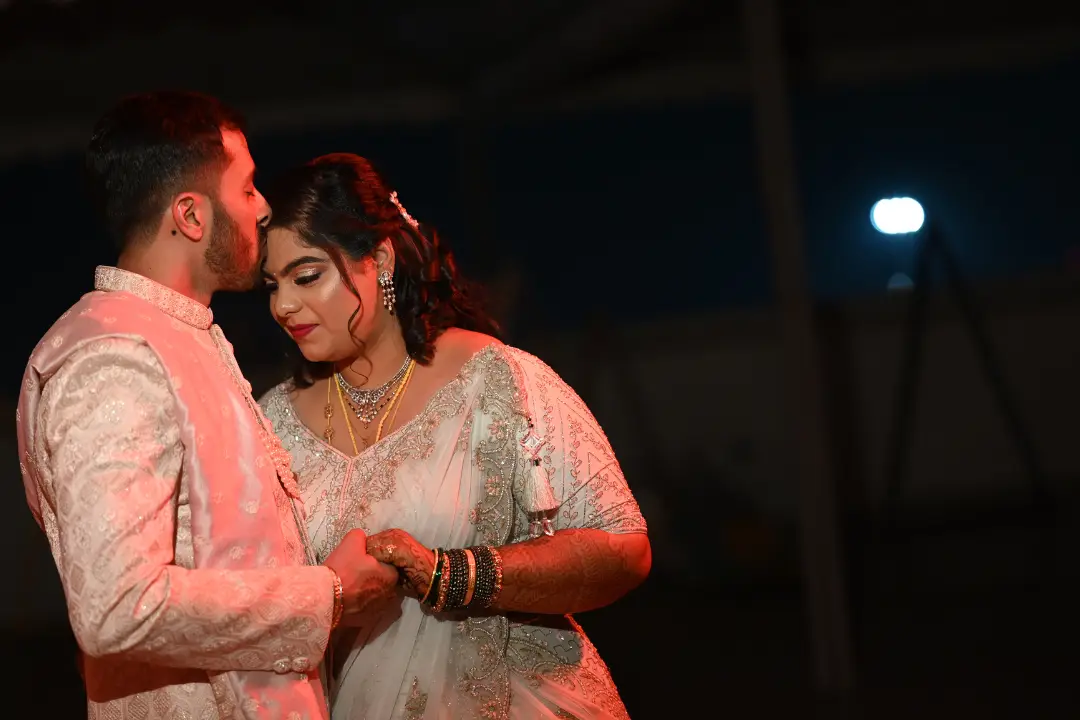 Bride and groom in a warm embrace during night wedding by best wedding planning company in bangalore