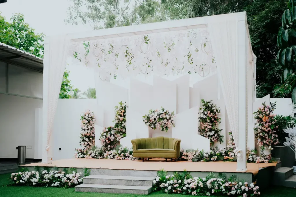 Minimalist white wedding stage with greenery and floral decor and Budget Wedding Planners in Bangalore