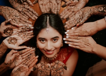 hands pointing to the bride on her mehandi ceremony - Wedding Photographers in Bangalore