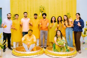 Family group photo during vibrant Haldi ceremony with yellow wedding décor in Bangalore - best wedding decoration in bangalore
