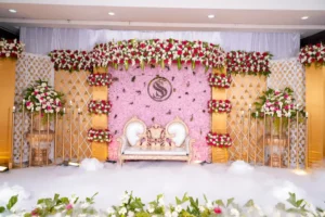 Wedding stage with pink floral backdrop and elegant seating in Bangalore