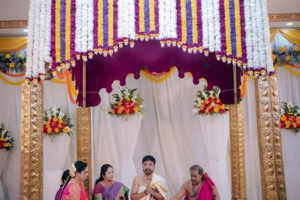Traditional South Indian mandap with purple and white floral drapes - wedding decorators in Malleshwaram