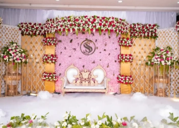 Wedding stage with pink floral backdrop and elegant seating in Bangalore