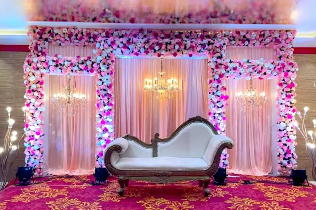 Elegant wedding stage decoration with pink and purple floral backdrop in Bangalore - Wedding Stage Decoration Ideas for Bangalore Couples
